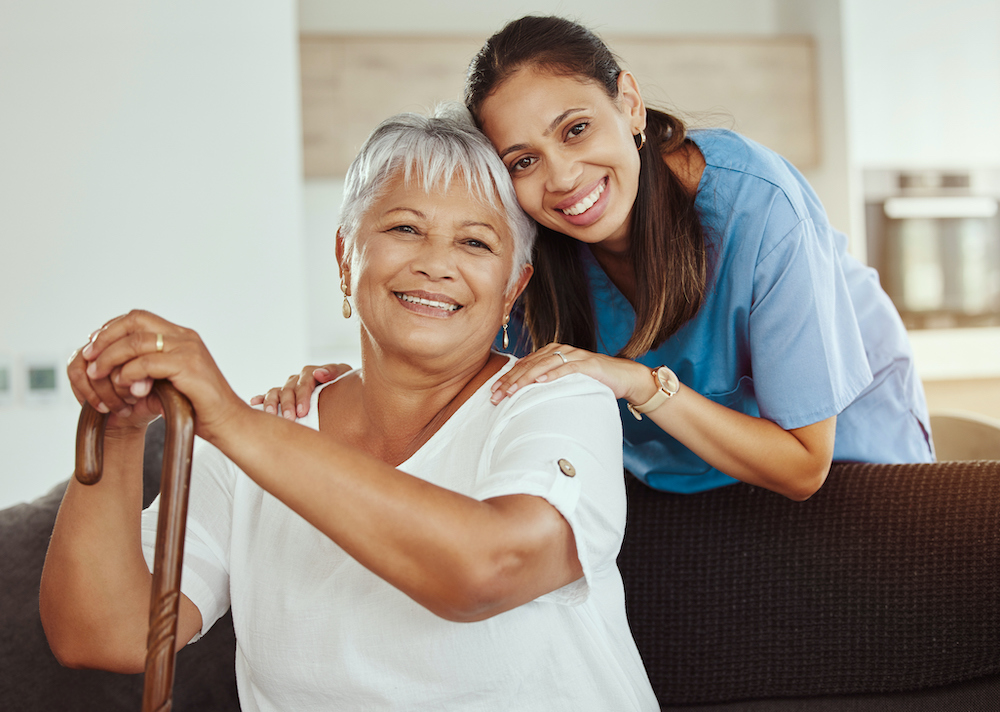 A woman and an older person smiling for the camera.