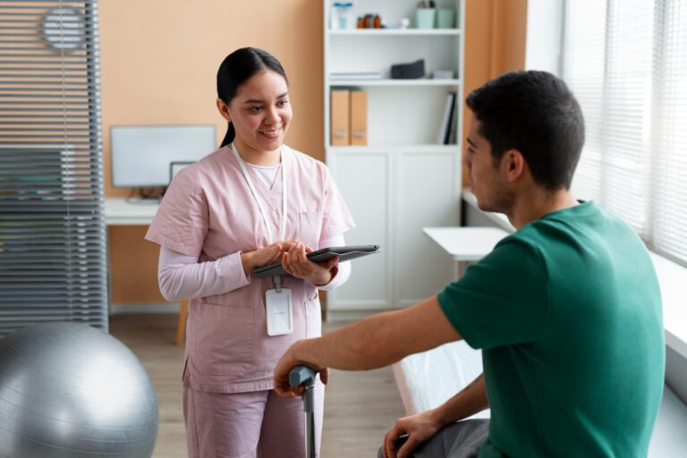 A woman in scrubs talking to a man.
