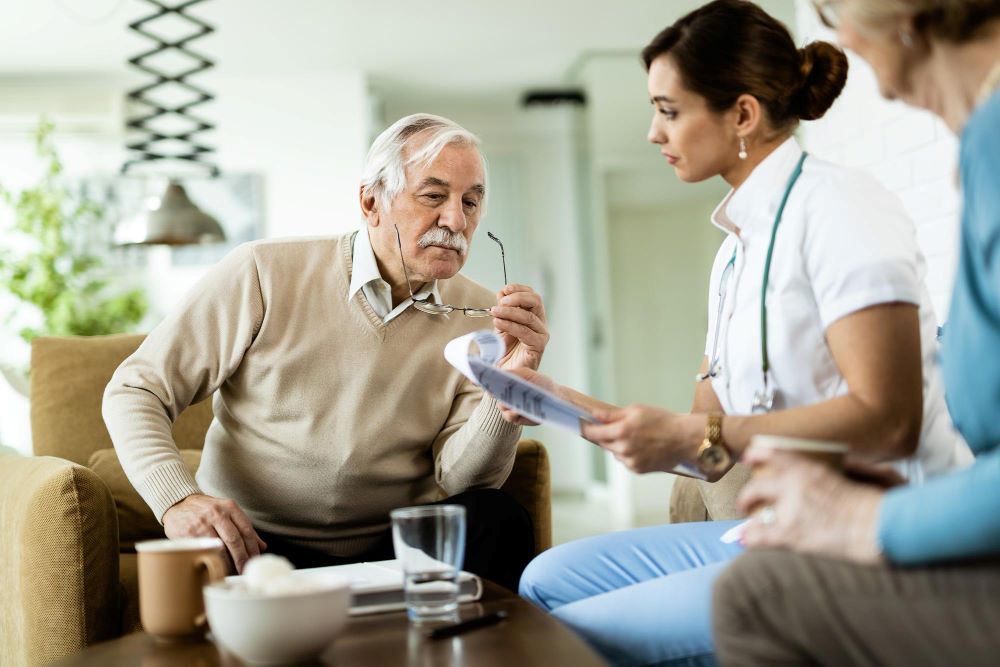 A woman is talking to an older man